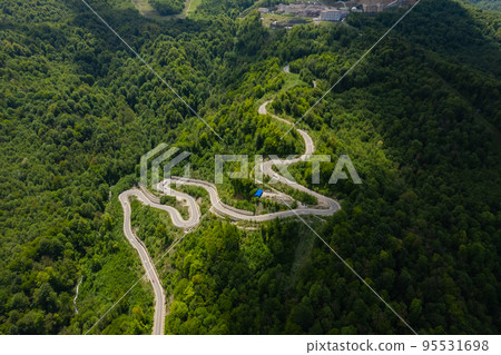 Aerial view of cars on a curvy road in mountain Aerial view of cars on a curvy road in mountain 95531698