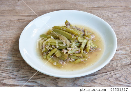 fried slice lotus stems with chop pork in soy sauce on plate 95531817