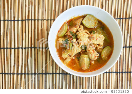 spicy boiled chicken with eggplant in curry soup on bowl 95531820