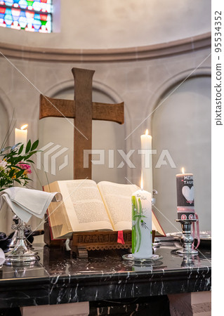 Festive interior decoration with burning candles in temple Church Christianity The ceremony of infant baptism Baptismal 95534352