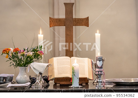 Festive interior decoration with burning candles in temple Church Christianity The ceremony of infant baptism Baptismal 95534362