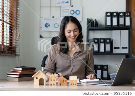 Woam agent calculating loan of finance and investment for real estate, businesswoman and invest in property about home, construction or mortgage of home. 95535116