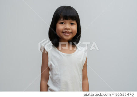 Portrait of happy and funny Asian child girl on white background, a child looking at camera. Preschool kid dreaming fill with energy feeling healthy and good concept 95535470