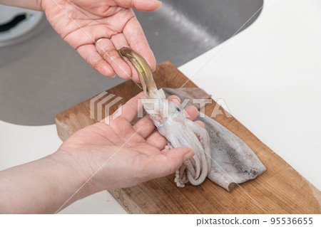 [A middle-aged housewife prepares a squid, taking out the liver] 95536655