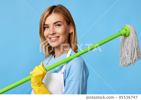 woman in rubber gloves holding mop and bucket woman in rubber gloves holding mop and bucket 95536747