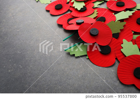 World War remembrance day. Red paper poppies on dark stone background 95537800