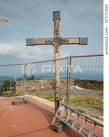 Historical wooden cross with text from the bible. Hochwald summit 95537899