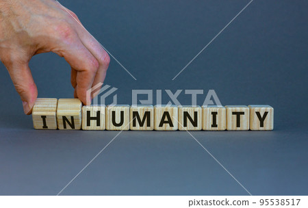 Humanity or inhumanity symbol. Businessman turns wooden cubes changes the word inhumanity to humanity. Beautiful grey table grey background, copy space. Business, humanity or inhumanity concept. Humanity or inhumanity symbol. Businessman turns wooden cubes changes the word inhumanity to humanity. Beautiful grey table grey background, copy space. Business, humanity or inhumanity concept. 95538517