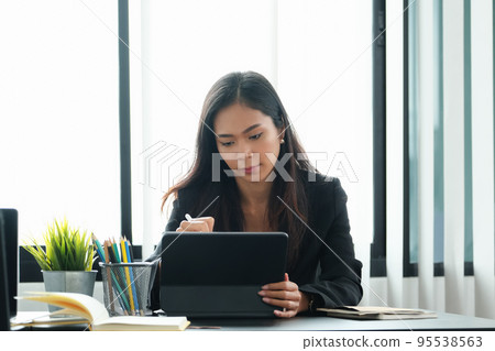 Business woman using tablet to review balance sheet annual using document to calculating budget. audit and Check integrity before investment concept 95538563