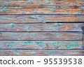 Old wooden painted green shield with cracks and scratches. 95539538