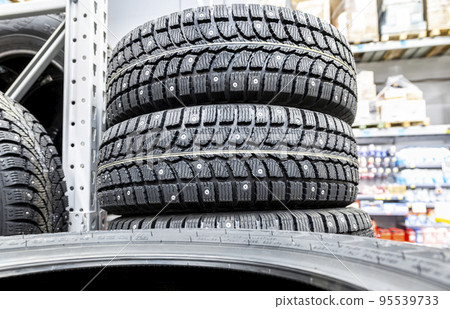 Winter vehicle tires stacked up for sale in the superstore Winter vehicle tires stacked up for sale in the superstore 95539733