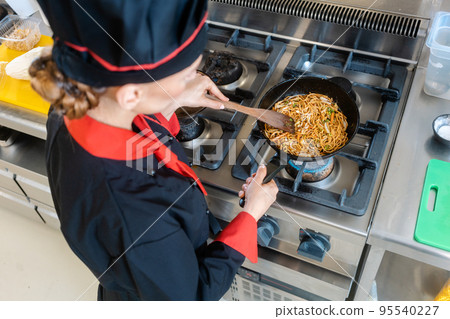 Chef pouring onion in a pan Chef pouring onion in a pan 95540227