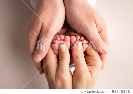 Mother and father are doing massage on her baby foot. Closeup baby feet in mother hands. Prevention of flat feet, development, muscle tone, dysplasia. Family, love, care, and health concepts. Mother and father are doing massage on her baby foot. Closeup baby feet in mother hands. Prevention of flat feet, development, muscle tone, dysplasia. Family, love, care, and health concepts. 95540808