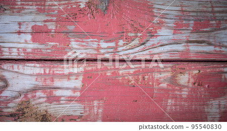 Color peels from the texture of the red painted wood surface 95540830
