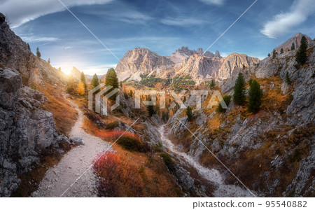 Beautiful mountain path, rocks and stones, orange trees at sunset 95540882