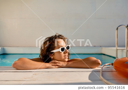 Young woman enjoy drinks at swimming pool 95541616