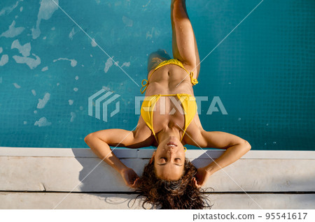 Young woman rest in swimming pool at resort Young woman rest in swimming pool at resort 95541617