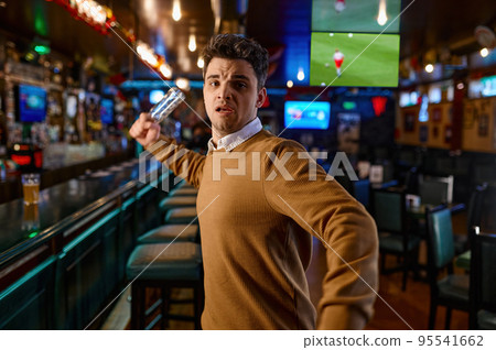 Angry man attacking with empty beer bottle Angry man attacking with empty beer bottle 95541662