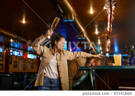 Unhappy and angry fans fighting at sport bar Unhappy and angry fans fighting at sport bar 95541668