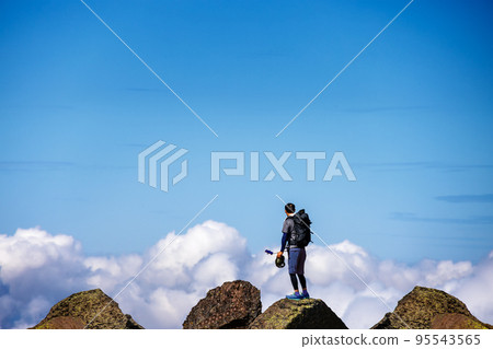 Blue sky, clouds and a mountain trail full of stones 95543565