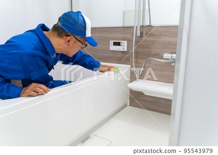 House cleaning male worker cleaning the bathroom 95543979