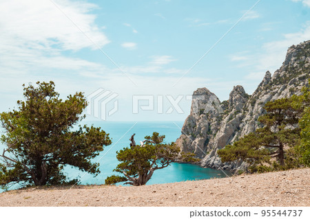 A scenic view of beach and coastal mountain A scenic view of beach and coastal mountain 95544737
