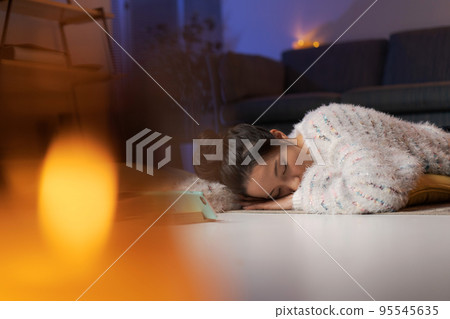 A woman relaxing at home at night A woman relaxing at home at night 95545635
