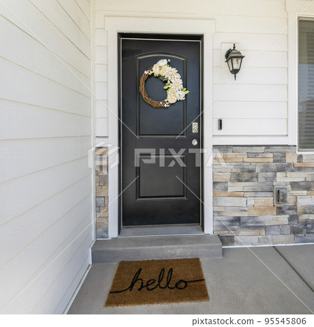 Square Black front door exterior with beautiful flower wreath decoration Square Black front door exterior with beautiful flower wreath decoration 95545806
