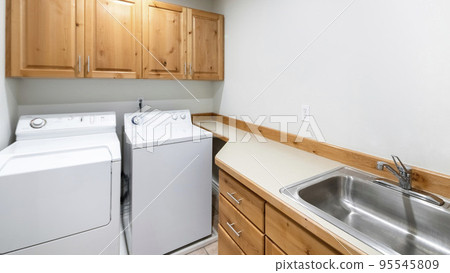 Panorama Craftsman style laundry room with two laundry units 95545809