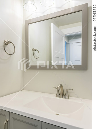 Vertical Single vanity sink in a small white bathroom with towel ring holder Vertical Single vanity sink in a small white bathroom with towel ring holder 95545812