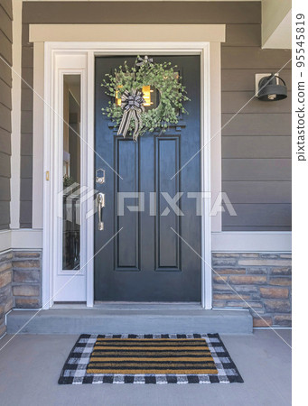 Vertical Black front door exterior with wreath and side panel Vertical Black front door exterior with wreath and side panel 95545819