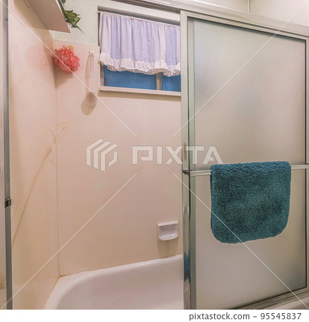 Square Bathroom interior with toilet paper and flowers in a box pot on top of the toilet Square Bathroom interior with toilet paper and flowers in a box pot on top of the toilet 95545837