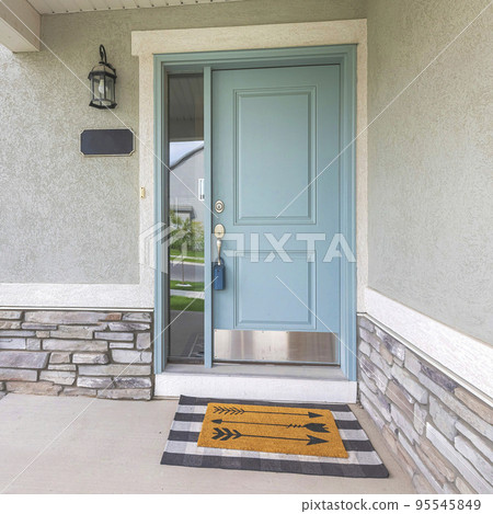 Square Light blue front door with lockbox and doormat on a concrete entrance Square Light blue front door with lockbox and doormat on a concrete entrance 95545849