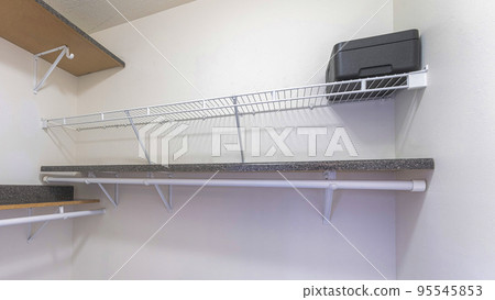 Panorama Walk-in closet interior with cork and metal shelves 95545853
