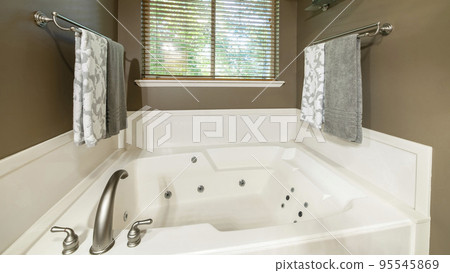 Panorama Alcove bathtub with deck mounted faucet near the window 95545869