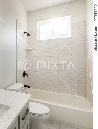 Vertical Sun flare Bathroom with window, white interior, and black fixtures Vertical Sun flare Bathroom with window, white interior, and black fixtures 95545890