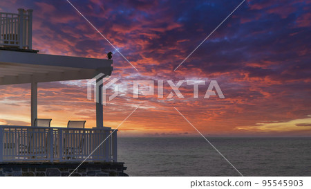 Panorama Dramatic sunset with clouds Beach house with bird near the balconies at La Jolla, California Panorama Dramatic sunset with clouds Beach house with bird near the balconies at La Jolla, California 95545903