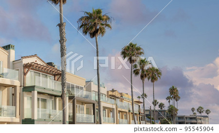 Panorama Puffy clouds at sunset Row of multi-storey houses with attached garage at La Jolla, Cal Panorama Puffy clouds at sunset Row of multi-storey houses with attached garage at La Jolla, Cal 95545904