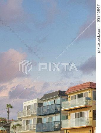 Vertical Puffy clouds at sunset Neighborhood residential buildings at La Jolla, California 95545947