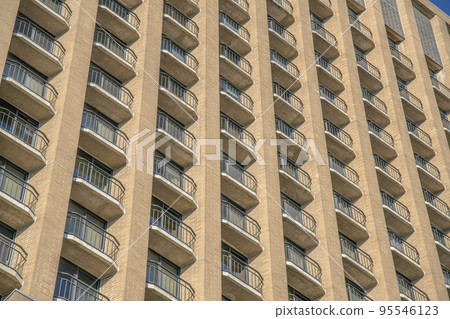 Austin, Texas- Low angle view of a multi-storey residential building with bricks and balconies 95546123