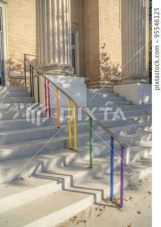 Austin, Texas- Wide stairs with floor-mounted handrails and painted colorful balluster Austin, Texas- Wide stairs with floor-mounted handrails and painted colorful balluster 95546125