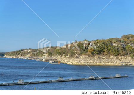Lake Austin, Austin, Texas- Docks at the front of the rich neighborhood on top of the slope Lake Austin, Austin, Texas- Docks at the front of the rich neighborhood on top of the slope 95546240
