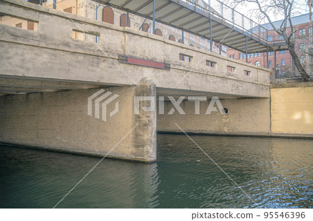 Concrete bridge over a canal at the famous San Antonio River Walk in Texas 95546396