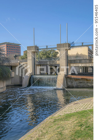 Sunny landscape of a canal and park at the San Antonio River Walk in Texas 95546405