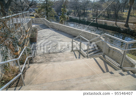 Outdoor stairs with view of the canal and park at San Antonio River Walk Texas Outdoor stairs with view of the canal and park at San Antonio River Walk Texas 95546407