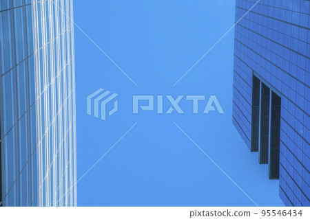 Looking up at the cloudless blue sky over modern buildings in Austin Texas 95546434