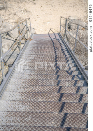 Outdoor staircase against dry sunlit ground near Lake Austin in Texas 95546476