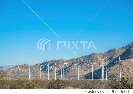 Palm Springs, California- Windmills on a shrubland near the mountain Palm Springs, California- Windmills on a shrubland near the mountain 95546836