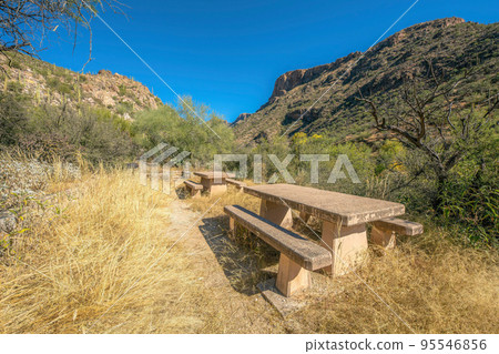 Dining tables on a camground with desert mountain view at Sabino Canyon State Park, Tucson, AZ Dining tables on a camground with desert mountain view at Sabino Canyon State Park, Tucson, AZ 95546856