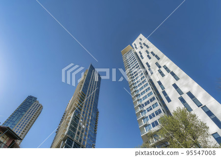 Residential buildings exterior in Austin Texas towering against vibrant blue sky 95547008